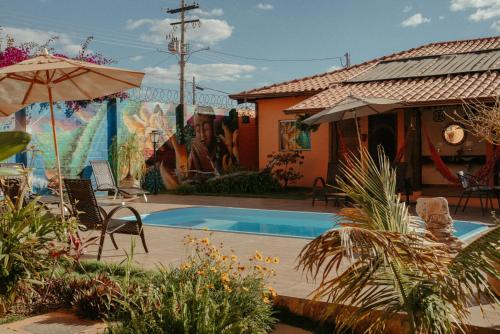 a house with a swimming pool in a yard at Pousada Lua Clara in Alto Paraíso de Goiás
