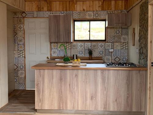 a kitchen with a wooden counter top in a room at Forel in Toconey