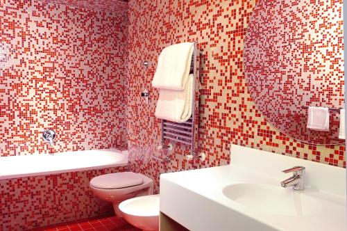 a bathroom with a sink and a toilet and a mirror at Hotel Abitart in Rome