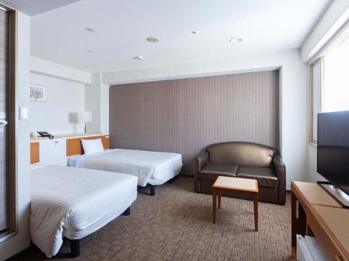 Hotel Wing Port Nagasaki tesisinde bir odada yatak veya yataklar