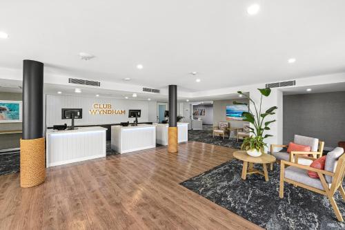 a lobby of a dental office with chairs and tables at Club Wyndham Flynns Beach, Trademark Collection by Wyndham in Port Macquarie
