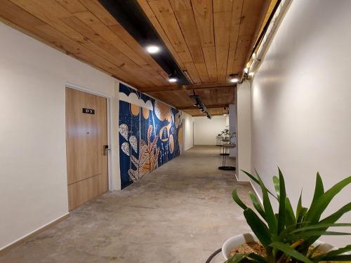 an office corridor with a hallway with a plant at DJourney Hotel Lembang by Escotel in Bandung