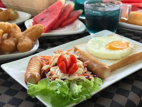 a plate of food with eggs on a table at Chanpraya Resort in Chanthaburi