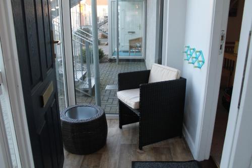 a room with a chair and a trash can at Serviced Apartments Wexford in Wexford