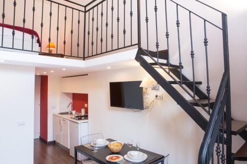 a living room with a staircase with a television at Appartamenti Mergellina in Naples