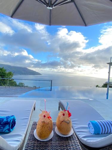 two cakes on plates on a table with a view of the ocean at Sorento Sur Mer in Victoria