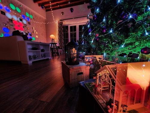a living room with a christmas tree with lights at Entire Villa Near Tbilisi Nature Reserve with Panoramic View in Mtskheta