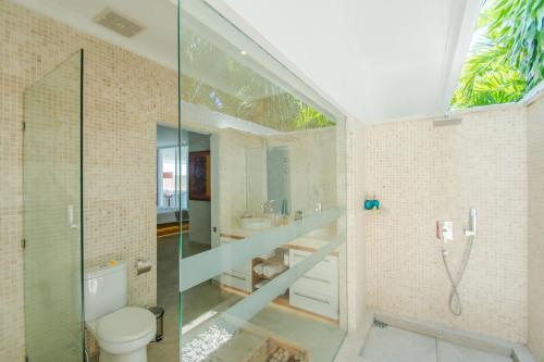 a bathroom with a glass shower and a toilet at Deep Blue Villa Bali in Umeanyar