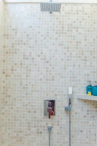a tiled wall with a tool at Deep Blue Villa Bali in Umeanyar