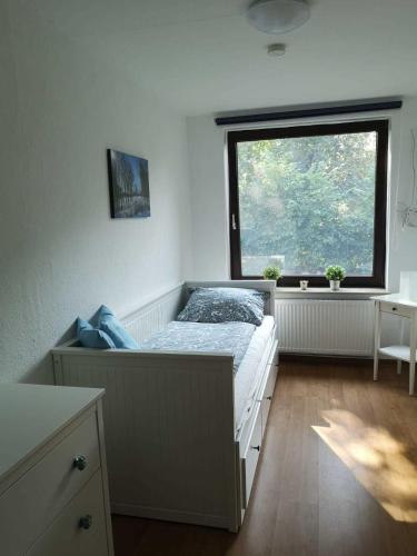 a bedroom with a bed in front of a window at Landoase - große Ferienwohnung mit toller Ausstattung, überdachter Terrasse und Garten in Kollerup