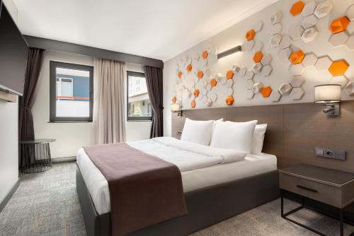 A bed or beds in a room at Days Hotel by Wyndham Ankara Cankaya