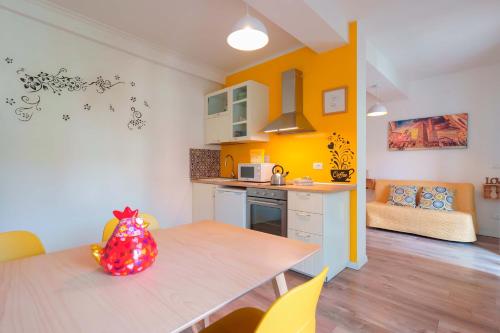 a kitchen with a table and a dining room at Dimora Orfeo in Bologna