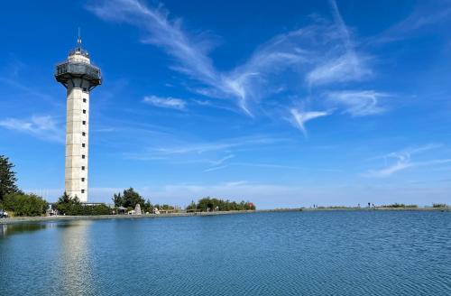 a lighthouse in the middle of a body of water at Landhaus am Itterbach Willingen in Willingen