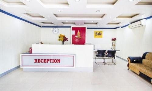 a waiting room with a reception counter and chairs at FabHotel Amaltas in Rānchī
