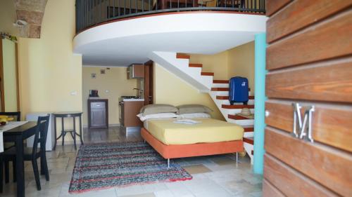 a bedroom with a bed and a staircase at Monteforte Resort in Ugento