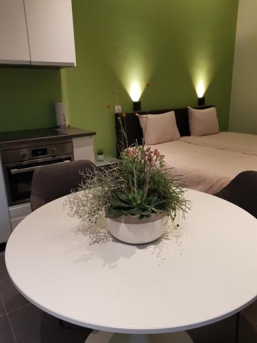 a living room with a white table and a bed at Touristflat Dewulf in Ghent