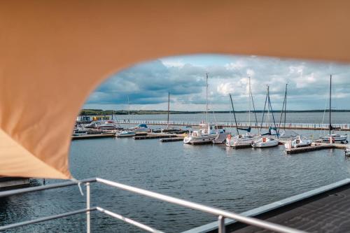 a group of boats docked in a marina at Floatinghouses Bärwalder See in Klitten