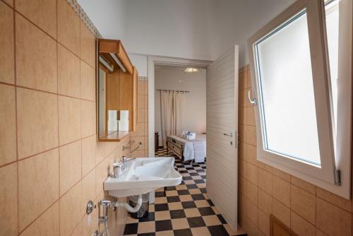 a bathroom with a sink and a window at Domo Sa Barra in SantʼAntìoco