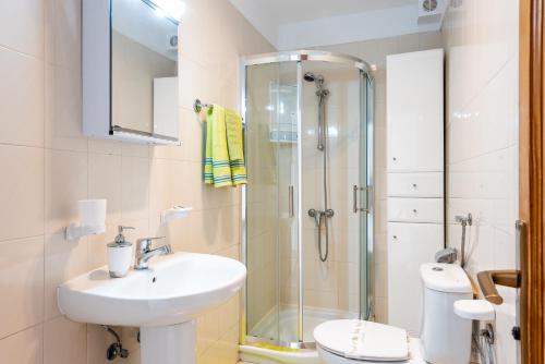 a bathroom with a shower and a sink and a toilet at Tenerife South Apartments in Playa de las Americas