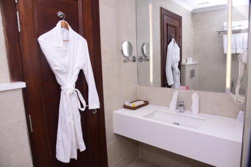 a bathroom with a sink and a mirror at Best Western Premier Hotel Gulberg Lahore in Lahore