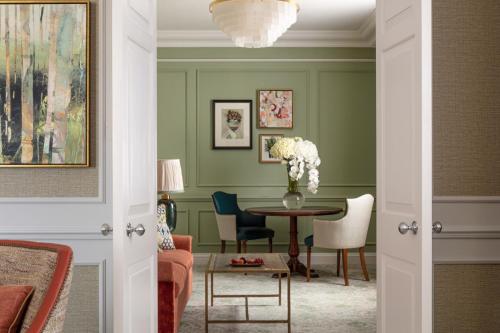 a dining room with green walls and a table and chairs at Four Seasons Hotel Hampshire in Winchfield