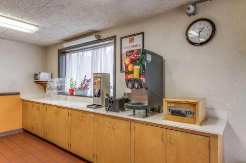 a room with a counter with a clock on the wall at Econo Lodge Eden in Eden