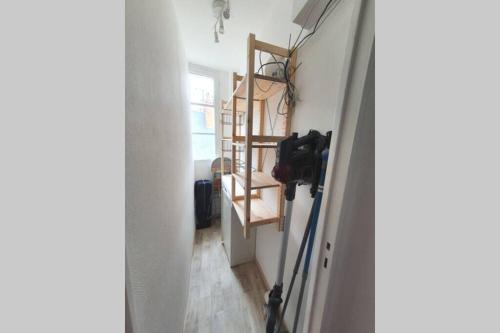 a hallway with a room with a camera on the wall at Appartement Loire et Château, Hyper Centre, vue Loire, Linge inclus, 3ème étage in Saumur