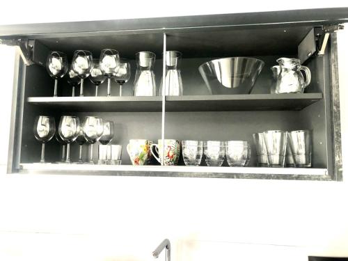 a shelf filled with lots of pots and pans at EL AGAVE DE MERESE APARTAMENTO in Las Toscas