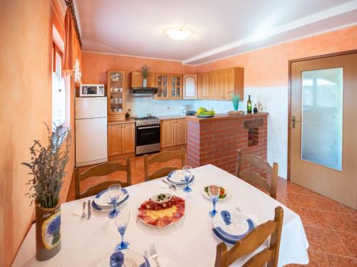 a kitchen with a table with a plate of food on it at Holiday Home Medica - PZN318 by Interhome in Tinjan