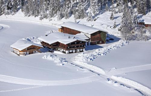 an aerial view of a lodge in the snow at Appartements Schrambacherhof in Achenkirch