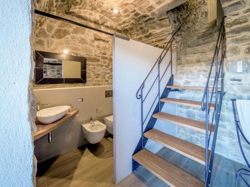 a bathroom with a staircase and a toilet and a sink at Holiday Home La Suite del Benessere by Interhome in Seggiano