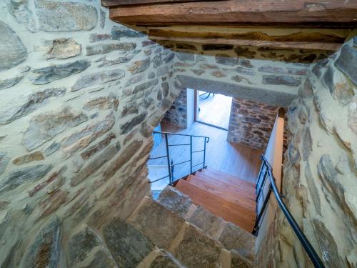 a staircase in a stone building with a stone wall at Holiday Home La Suite del Benessere by Interhome in Seggiano