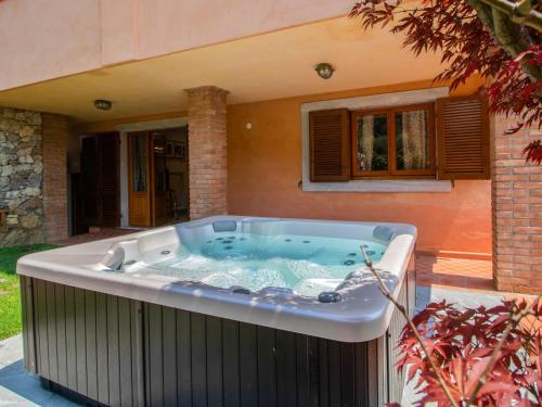 a large hot tub sitting outside of a house at Apartment Serenella by Interhome in Pietrasanta