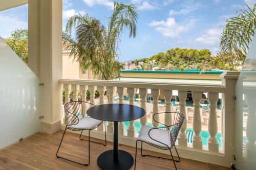 a balcony with a table and chairs and a view of the water at Barceló La Nucía Palms in La Nucía