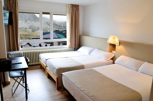 a hotel room with two beds and a window at Hotel Terranova in Pas de la Casa