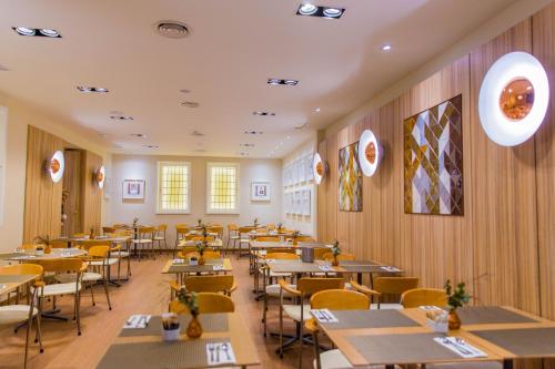 a restaurant with tables and chairs in a room at Hotel Opera in Madrid
