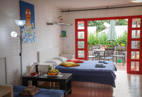a bedroom with two beds and a patio with a table at Los Geranios, Close to BEACH, Puerto Colon, YellowCat 2 in Adeje