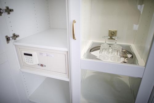 a small white cabinet with a sink in it at Villa Basileia Riverside in Karlovy Vary