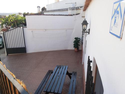 a blue bench sitting on a balcony next to a building at Casa Cueva EL ZAGAL in Guadix