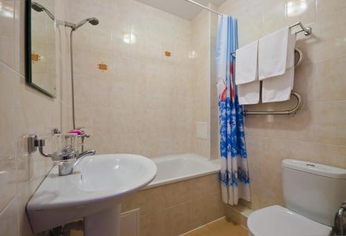 a bathroom with a sink and a toilet and a shower at Отель Застава in Anapa