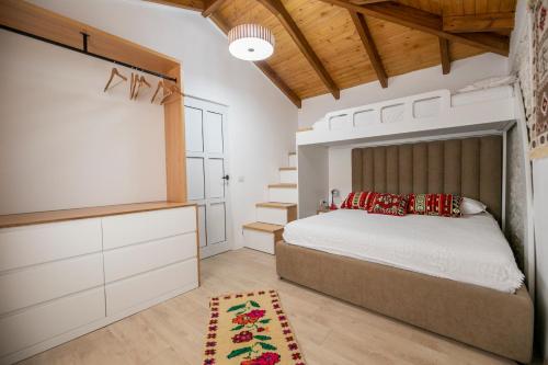 a bedroom with a bed and a dresser at Vila Leon - Old Qeparo - 6 people in Qeparo