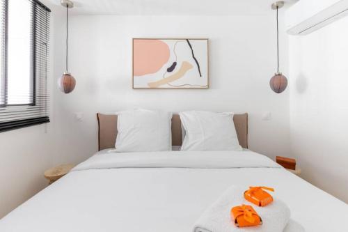 um quarto com uma cama com sapatos laranja em HSH Invalides-Palais Bourbon Luxueux Appartement 4P em Paris