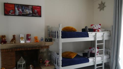 two bunk beds in a room with a fireplace at Residence Alassa in Montévrain