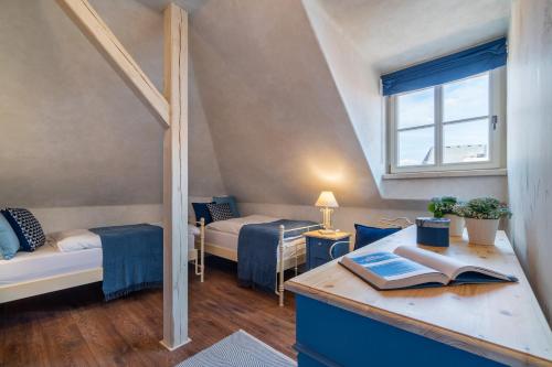 a room with a desk with a book on it at Boutique hotel Soukeníkův dům in Kutná Hora