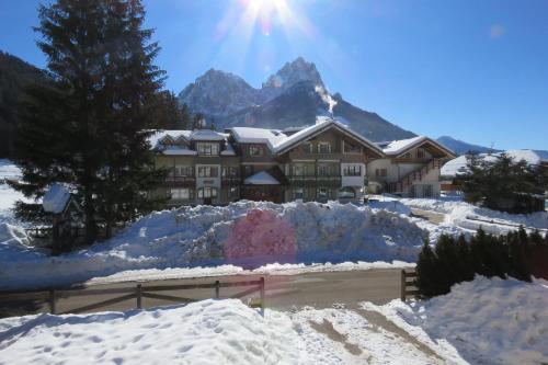 a lodge in the mountains covered in snow at Residence Holiday in Pozza di Fassa