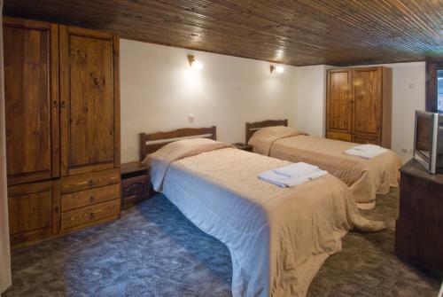 a bedroom with two beds and a tv in it at Complex Balgarka in Tryavna