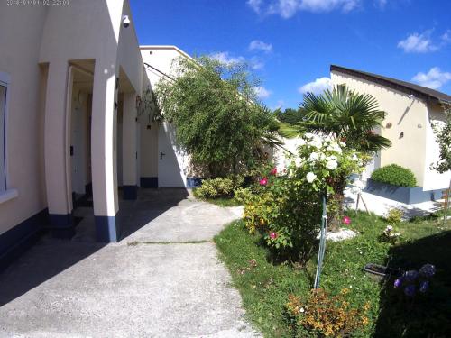 a walkway next to a building with flowers and plants at Residence Alassa in Montévrain