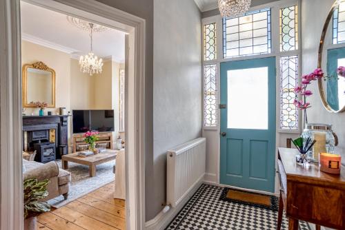 a living room with a blue door at The Beach House - Cromer in Cromer