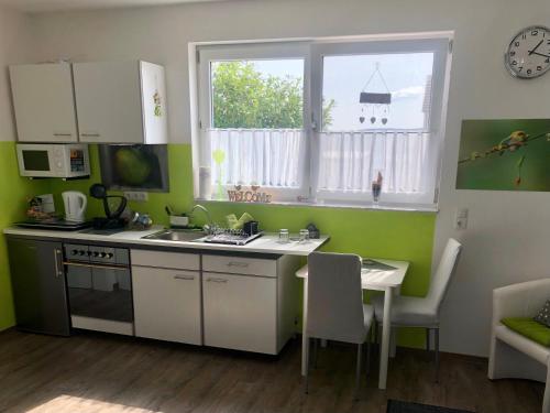 a kitchen with a sink and a table and a window at Apartment Oase- Kaiserslautern in Kaiserslautern