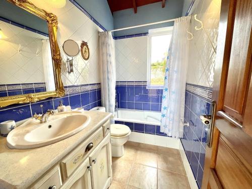a bathroom with a sink and a toilet and a mirror at Apartamento MAR Y TEIDE in Sauzal